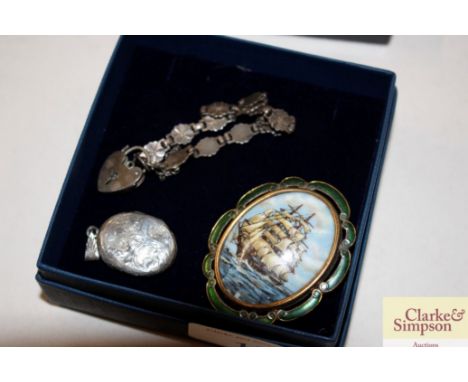 An enamel and yellow metal ship decorated brooch; a white metal pendant; bracelet and a pair of earrings