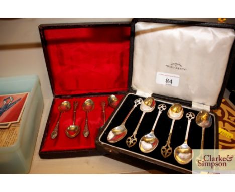 A cased set of six silver teaspoons; and a cased set of six plated Art Nouveau design teaspoons 