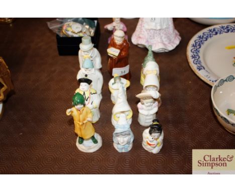 Eleven Royal Worcester candle snuffer figures and a Royal Worcester figure "Fisherman"