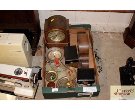 A tray box and contents containing various mantel clocks, metalware, plated chamber stick etc.