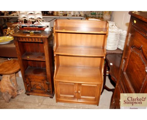 An Ercol graduated bookcase with cupboard below 