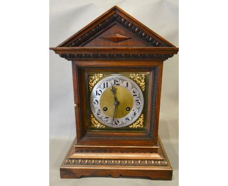 An Early 20th Century Oak Mantel Clock, the brass dial with Arabic numerals and two train movement, 38cm tall 