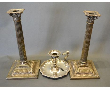 A Pair of Silver Plated Corinthian Column Candlesticks, 29.5cm tall, together with a silver plated chamber stick 