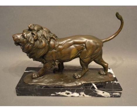 A Patinated Bronze Model in the Form of a Lion upon rectangular variegated marble plinth, 33cm long 