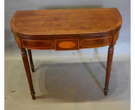 A 19th Century Mahogany Card Table, the crossbanded top enclosing a baize lined interior above an inlaid frieze, raised upon 