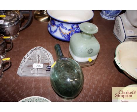 An Edinburgh crystal golfing paperweight; a hand made glass bottle vase; and a green glass flask 