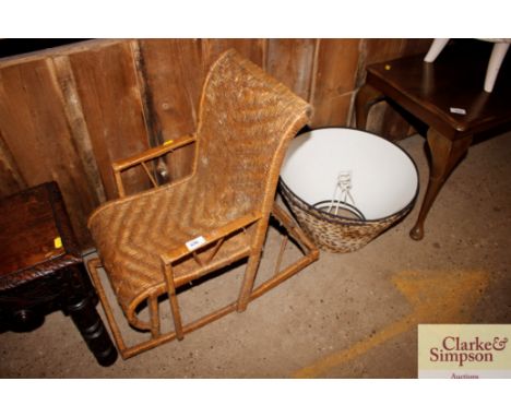 A child's vintage wicker rocking chair and two leopard skin effect light shades 