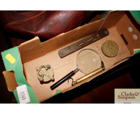 A brass mounted spirit level; a large magnifying glass; a set of Eastern style bronze weights; a spring balance etc.