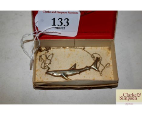 A 9ct gold dolphin pendant hung to a fine link chain, 1.7gms