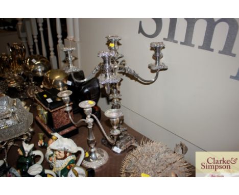 An ornate plated five light candelabra; and a three light plated candelabra 