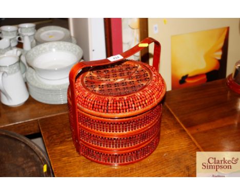 A Malayan three tier food basket and ladle 