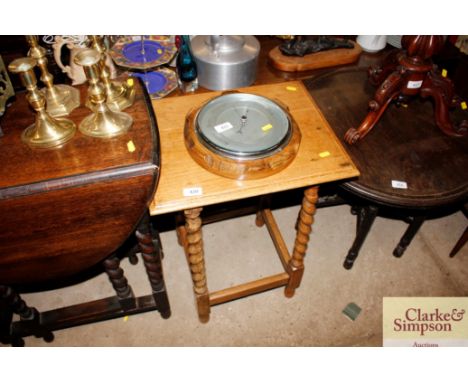 A light oak occasional table on barleytwist supports 