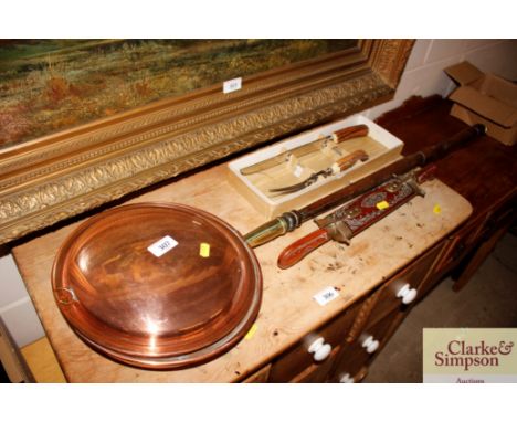 A copper warming pan with turned wooden handle; an Eastern carved hardwood cased carving set; and a horn handled carving knif
