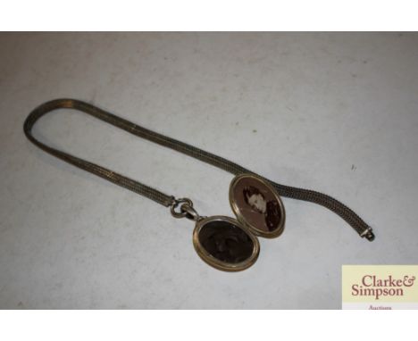 A large foliate engraved white metal locket and chain 