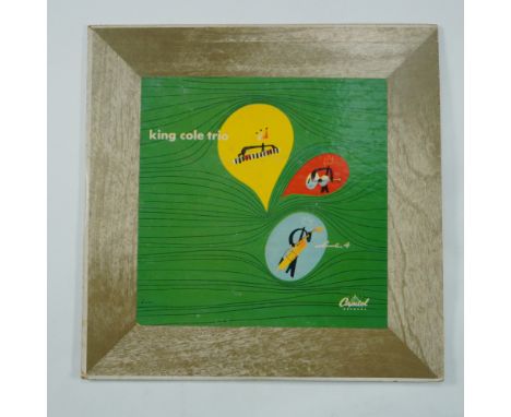 This vintage vinyl record album, King Cole and His Trio, Vol. IV, features Nat "King" Cole and his renowned jazz trio. Releas