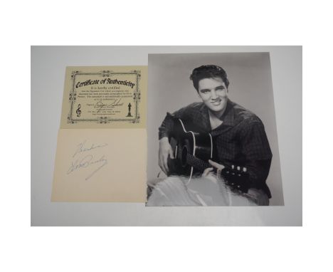 An exceptional Elvis Presley autograph, inscribed with "Thanks, Elvis Presley" in blue ink on a vintage album page. Accompani