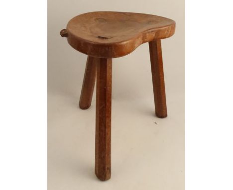 A Robert Mouseman Thompson three legged stool, with shaped seat and chamfered legs, height 14ins