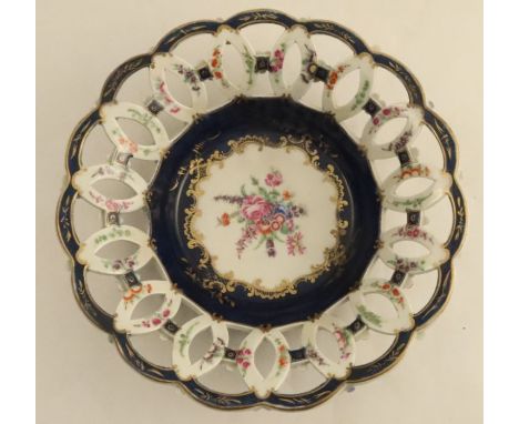 A basket, in the Worcester style, with open work sides, decorated to the centre with a floral bouquet, blue seal mark, diamet