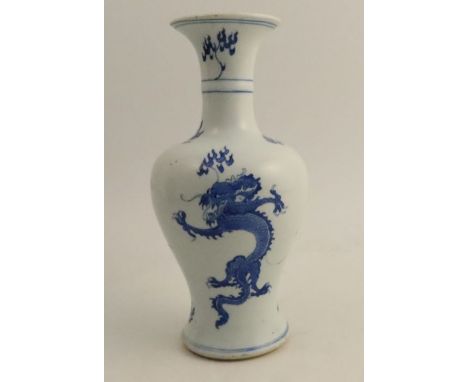 A Chinese Kangxi vase, decorated with dragons and symbols in blue and white, leaf mark to base, height 10ins - There are cert