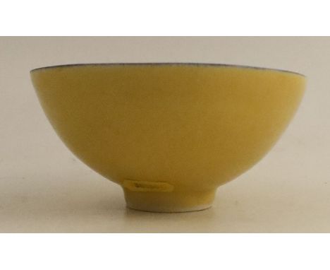 Dame Lucie Rie, a footed bowl, decorated with a bright yellow glaze and a blue line to the rim, impressed seal mark, diameter