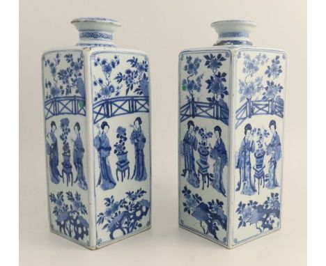 A near pair of Chinese Kangxi canister vases, decorated with figures with a fence and foliage, two differing square marks to 