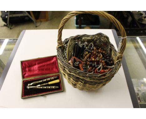 A basket containing various costume jewellery; an Art Nouveau style circular brass photograph frame; a cased nut cracker and 