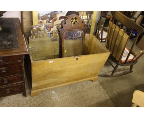 A light wood blanket box with carrying handles 
