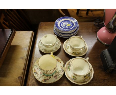 A quantity of blue and white plates; and four teacups and saucers 