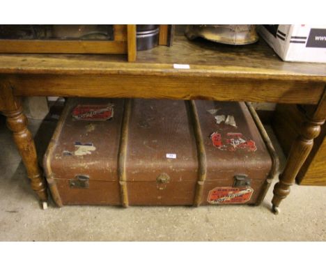 A large wooden bound travelling trunk 