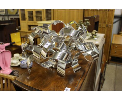 An unusual chromed metal light fitting 