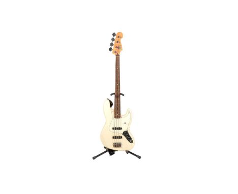 A Fender Mexico Jazz bass guitar, with maple neck, rosewood fretboard, two single coil pickups, cream finish, moulded Stagg p