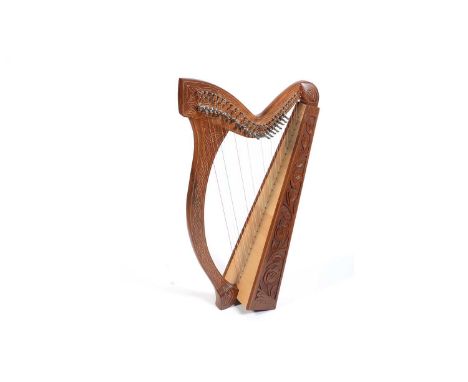 A Celtic or Irish harp, hardwood frame with Celtic line decoration and carved with roses, spruce soundboard, 96cms, carry bag