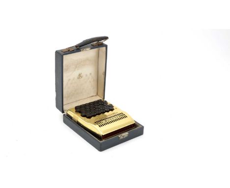 A Hohner model number 8802/72 harmonetta with gold-anodized covers, in original box.