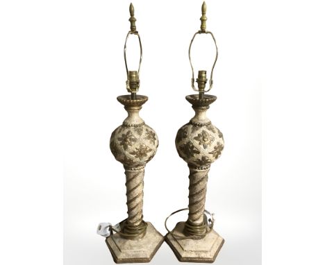 An ornate pair of contemporary cream and gilt lamp bases, height 78 cm.