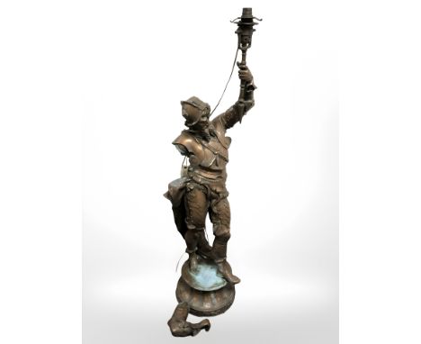 A patinated metal figural standard lamp in the form of a conquistador (as found), height 107 cm.