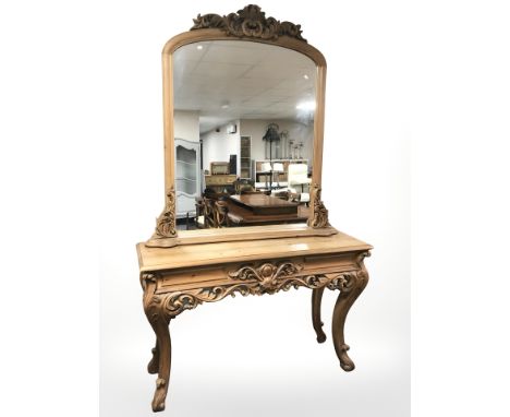 A heavily carved pine console table and mirror above, overall 138 cm x 42 cm x 224 cm.
