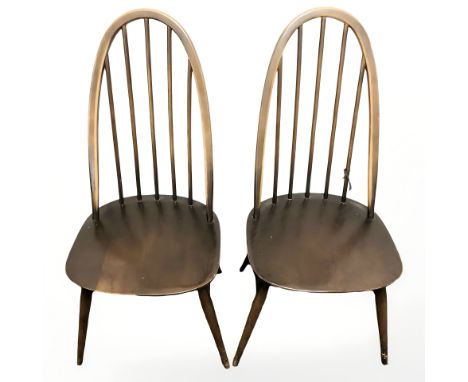 A pair of Ercol stained elm spindle back dining chairs.