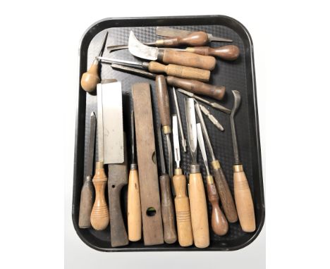 A group of wood working chisels, saw, level and similar tools 