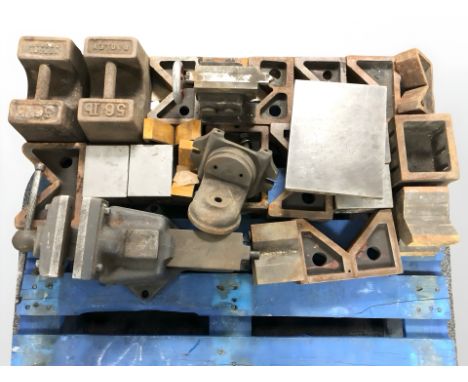 A large cast iron bench vice, two 56 pound cast iron weights, smaller vice and similar items. 