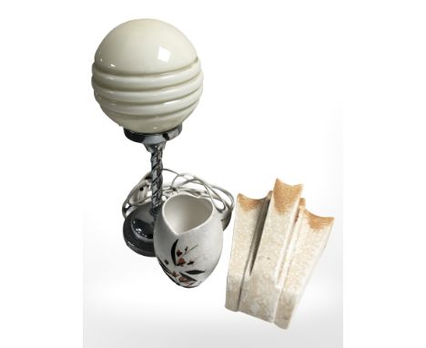 A chrome plated Art Deco twist stem table lamp with opaque glass shade, with a wall pocket and Sarn pottery vase 