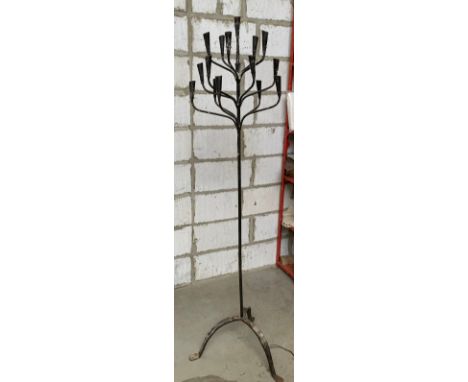 A wrought iron sixteen arm floorstanding candelabra, on a tripod base, 178cmH 