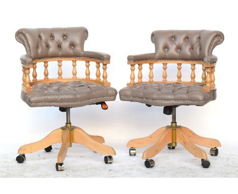 A pair of contemporary Italian grey vinyl and beech captains swivel office chairs, button upholstered, in a 19th century form
