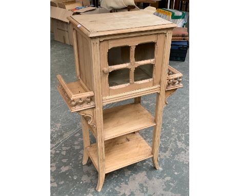 An Aesthetic movement pine cabinet, glazed door flanked by shelf either side, two shelves below, 69x35x102cmH 