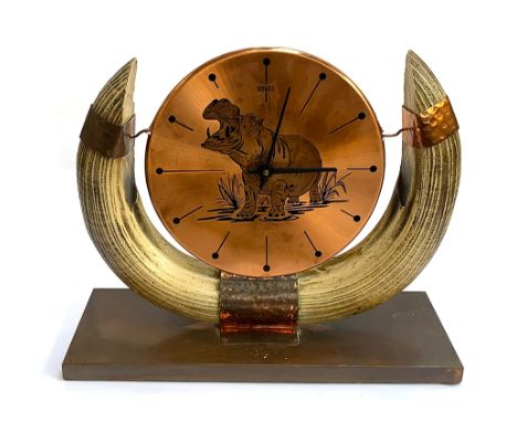 A vintage German Kienzle copper and resin horn mantle clock decorated with an image of a hippo, 34cmH; together with a carved