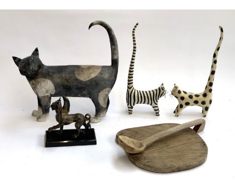 A large studio pottery cat (leg repaired), 33cmL; together with a pair of wooden cats; a resin Griffin; and a wooden ladle an