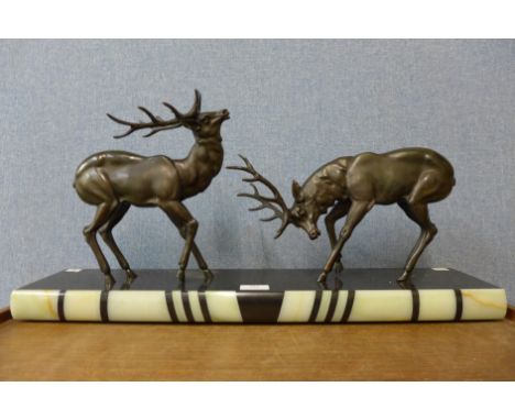 An Art Deco spelter figure of two deer's, on marble plinth, a/f 