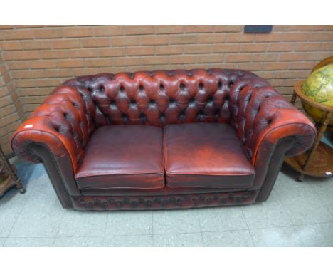 A red leather Chesterfield two seater settee 