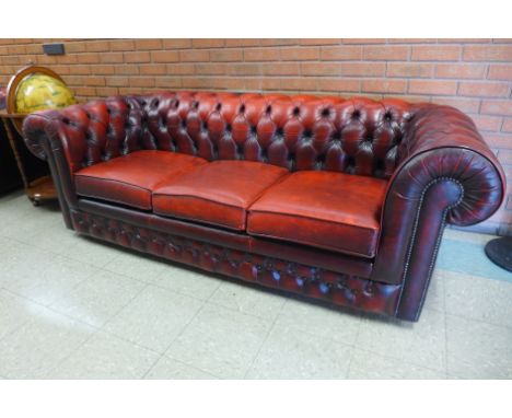 A red leather Chesterfield three seater settee 