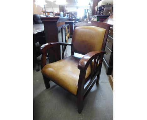 An Art Deco style hardwood and upholstered armchair 