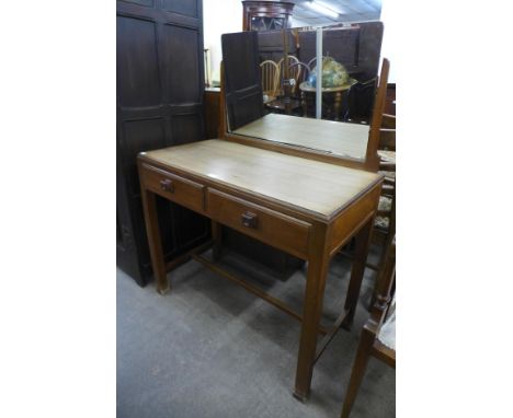 An Art Deco walnut two drawer dressing table, manner of Heals, London 